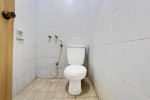 a bathroom with a toilet and a shower at OYO 3934 Hotel Istana in Pekalongan +23 photos