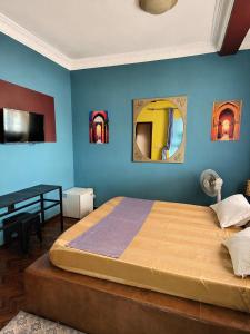 a bedroom with a large bed and two mirrors at Hôtel la medina in Antananarivo
