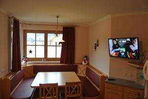 a living room with a table and a tv at Kugellehen in Radstadt