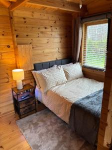 a bedroom with a bed in a log cabin at Trelew Farm Log Cabin in Penzance