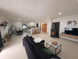 a living room with a couch and a fireplace at Ferienwohnung "Zum Pfadfinder" in Thalfang