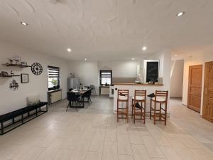 a kitchen and living room with a table and chairs at Ferienwohnung "Zum Pfadfinder" in Thalfang