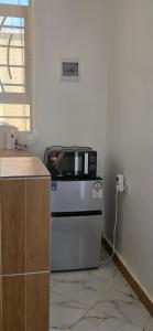 a microwave sitting on top of a stove in a kitchen at Mihambos one bedroom in Msambweni +9 photos