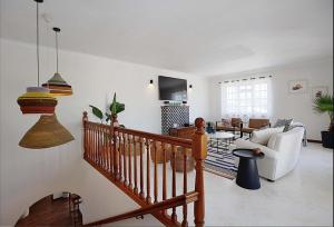 a living room with a wooden staircase and a living room at Hacienda in Cape Town