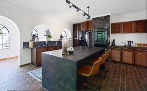 a kitchen with a large island in the middle at Hacienda in Cape Town