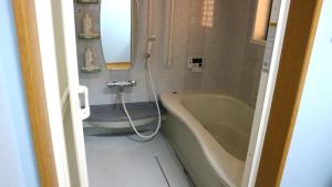 a bathroom with a tub and a toilet and a sink at Sakuraya 亀島店 in Nagoya +12 photos