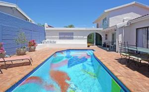 a large swimming pool in the backyard of a house at Hacienda in Cape Town