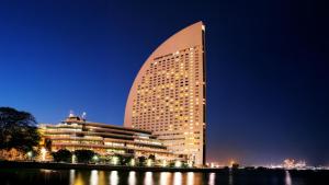 a large building is lit up at night at InterContinental Yokohama Grand by IHG in Yokohama