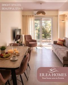 a living room with a table and a couch at EREA Homes Apartments in Eretria