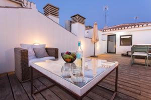 a table with glasses and a bottle on a patio at Realejo Horizon por Miwa Studio in Granada
