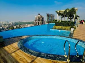 a swimming pool on the roof of a building at The Grand Anukampa in Jaipur