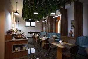 a restaurant with tables and chairs and a bar at Isra City Hotel in Dushanbe