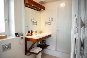 a bathroom with a sink and a shower at Hotel Les Almadies - Coeur de Ville in Saint-Jean-de-Luz +42 photos