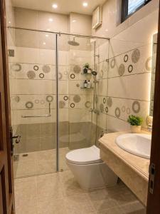 a bathroom with a shower and a toilet and a sink at Nguyên căn villa Đà Lạt in Da Lat
