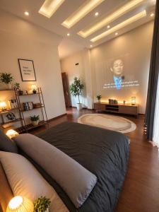 a bedroom with a large bed with a movie projected on the wall at Nguyên căn villa Đà Lạt in Da Lat
