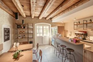 a kitchen with wooden ceilings and bar stools at Albola Suite Holiday Apartments in Riva del Garda