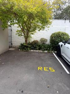 a white car parked in a parking lot at Sonique-Uniqueness Crib in Cape Town