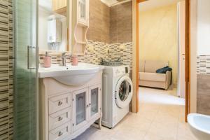 a bathroom with a sink and a washing machine at Casa nel Borgo in Campomarino