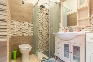 a bathroom with a shower and a toilet and a sink at Casa nel Borgo in Campomarino