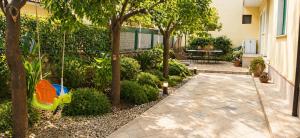 a garden with a swing and a playground at Sweet Holidays al centro di Formia in Formia +3 photos