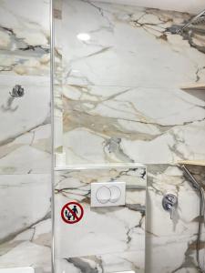 a shower with a glass door in a bathroom at Duka Rooms in Himare +21 photos