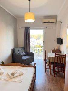 a living room with a bed and a couch and a table at Duka Rooms in Himare