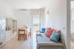 a kitchen and living room with a couch and a table at Italian Experience-Suite Riviera in Porto Recanati