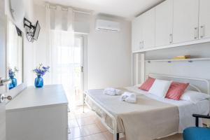 a white kitchen with a bed in a room at Italian Experience-Suite Riviera in Porto Recanati +30 photos
