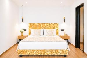 a bedroom with a large bed with a gold headboard at Nobile Boutique Hotel in Agios Gordios