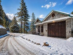 a house with a garage in the snow at Luxury Noor Villa in Khaira Gali