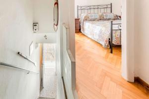 a bedroom with a bed and a door to a hallway at Casa Lia Family-Friendly Holiday Home in Sala Comacina