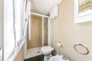 a small bathroom with a toilet and a shower at Casa Lia Family-Friendly Holiday Home in Sala Comacina +39 photos