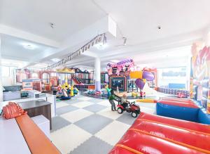 a childrens play room with a child riding a scooter at Ucha Hotel & Suites in Kampala