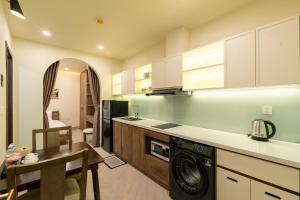 a kitchen with a washer and dryer in a room at Weal Apartment in Danang +32 photos