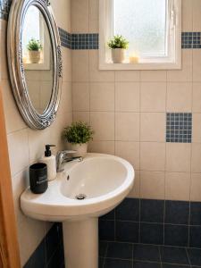 a bathroom with a sink and a mirror at Seaside Green Villa in Karianí