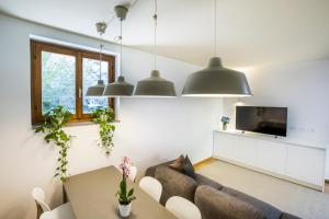 a living room with a couch and a tv at La Ca di Nosee in Nesso
