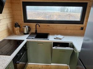 a small kitchen with a sink and a window at Domki Lubikowo in Przytoczna 