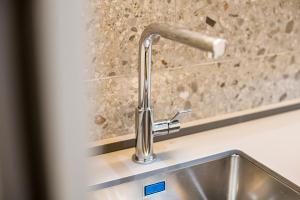 a kitchen sink with a faucet on a counter at La Ca di Nosee in Nesso +71 photos