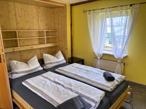 a bedroom with two beds and a window at Möllers Morgen in Lentföhrden +76 photos