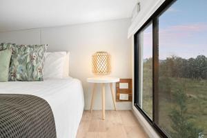 a bedroom with a bed and a large window at Yellow Rock Views by Tiny Away in Broke