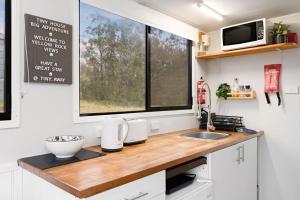 a kitchen with a counter with a sink and a window at Yellow Rock Views by Tiny Away in Broke