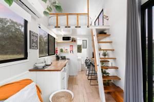 a tiny house with a kitchen and a loft at Yellow Rock Views by Tiny Away in Broke +19 photos