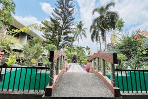 a bridge over a pool at a resort at Maharajah Hotel Angeles City in Angeles