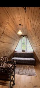 a large room with a bed and a window at LUNEA cottage in Machakhlispiri