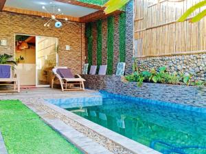 a swimming pool in the backyard of a house at Charming House with Private Pool in Bacolod