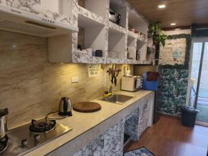 a kitchen with a sink and a counter top at Charming House with Private Pool in Bacolod