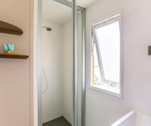 a bathroom with a shower and a window at Cottage PARKS OLVA in Sartène +24 photos