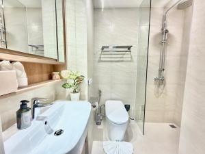a bathroom with a toilet and a sink and a shower at Skypark Laguna Phuket by Escape Villas in Laguna Phuket +15 photos