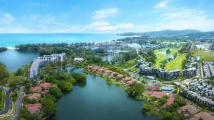 an aerial view of a city next to a body of water at Skypark Laguna Phuket by Escape Villas in Laguna Phuket
