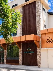 a building with a sign for majorette suites at Magnolia Suites B&B in Dar es Salaam